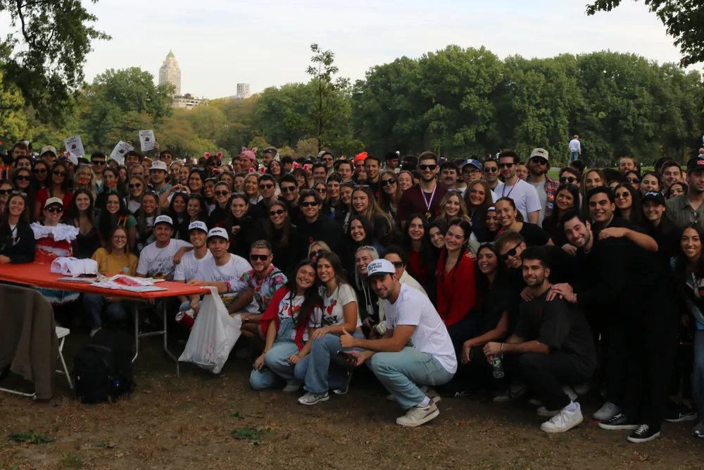 A large group of scavenger hunt participants gathered in a New York City park